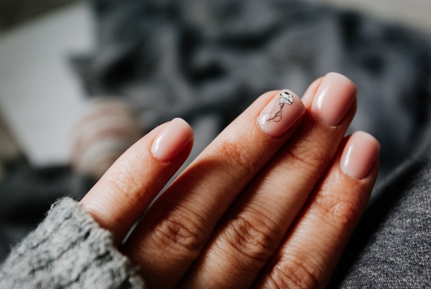 Nude gel manicure with a chrome accent nail